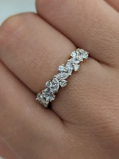 a woman's hand with a diamond ring on it