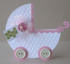 a pink and white baby carriage with buttons