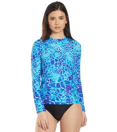 The EQ Swimwear Belize L/S Rash Guard will have you channeling your island flair every time you wear this great piece. With chlorine resistant fabric, this rashguard will last you for years to come in and out of the pool and from the harsh sunlight. Benefits Women’s rash guard. Maximum chlorine resistance reduces fabric breakdown.  Excellent stretch and recovery characteristics retains shape and support.  Low absorbency and quick drying technology enhances your comfort out of the water.  Color-fast technology resists fading.  Durable long sleeve rashguard.  Protects against the cold water.  Unlined: For lighter weight comfort.  Each EQ piece is individually cut and sewn together, not mass produced. Every seam is stitched for maximum durability and performance.  All pieces are designed and Crew Neck Swimwear With Upf 50+, Upf 50+ Crew Neck Swimwear, Fitted Crew Neck Swimwear For Beach Season, Fitted Crew Neck Swimwear For Beach, Printed Rash Guard For Surfing Beachwear, Blue Stretch Rash Guard For Beach, Printed Rash Guard For Swimming Beachwear, Printed Rash Guard For Beach, Stretch Blue Rash Guard For Beach