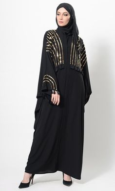 Featuring a kimono style flared abaya dress in nida fabric adorned with gold sequinned panels the all over the front bodice till the waist and sleeves. It is accentuated with thread fringes detail at the edges of sleeves and front embroidery. It has a loose silhouette perfect to be worn for evening wear ensemble.FIT : Relaxed fit.COMPOSITION : Nida.CARE : Dry clean only. Eid Floor-length Sequined Kaftan, Gold Floor-length Abaya For Evening, Gold Floor-length Thobe For Party, Gold Thobe For Festive Evening Occasions, Gold Sequined Dresses For Eid, Gold Floor-length Party Abaya, Gold Floor-length Abaya With Gold Embroidery, Gold Embroidered Floor-length Abaya, Gold Embellished Maxi Kaftan