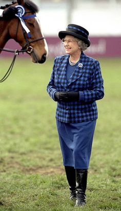 an older woman walking next to a brown horse