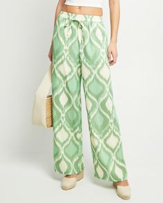 Price Comparison Few Moda $49 STAUD $275 Reformation $198 Product Details The Kiara Pant offers the perfect blend of style and comfort. Featuring an elastic waist and convenient pockets, these pants are made from a breezy linen blend and boast a fun print that adds a touch of playfulness. The relaxed fit ensures all-day comfort and effortless style. - Elastic waist- Drawstring tie- Content: Main Fabric: 20% Linen, 80% Rayon; Lining: 100% Cotton Style# K24WPA00012 Fit Notes - Model wearing a size Green Pull-on Straight Pants, Green Tapered Leg Pants With Pull-on Style, Green Pants With Pockets For Vacation, Chic Green Relaxed Fit Bottoms, Green Cotton Wide Leg Pants For Vacation, Green Cotton Wide Leg Vacation Pants, Green Relaxed Fit Wide-leg Pants, Green Wide-leg Bottoms With Elastic Waistband, Green Wide Leg Bottoms With Elastic Waistband