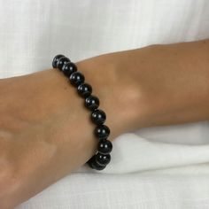 This beautiful black beaded bracelet is made with 8mm black tourmaline beads. Tourmaline is known for its unique ability to emit negative ions, which are believed by many ancient cultures to have spiritual significance. The bracelet is perfect for anyone looking for deep meaningful meditation on their aura or adding a touch of style to their outfit. Whether you wear it as a fashion statement or use it as a tool for meditation and a spiritual symbol, this bracelet is sure to become one of your favorite accessories.

 

 	Free Shipping 2 Days
 	Size: Adjustable, 8MM
 	Material: Authentic Stone, Black Tourmaline
 	Color: Black
 	Style: Beaded Bracelet Spiritual Black Hand-strung Bracelet, Spiritual Black Hand-strung Bracelets, Black Gemstone Beads Rosary Bracelet, Spiritual Hand-strung Black Bracelets, Black Beaded Bracelets With 8mm Beads For Healing, Black Stretch Bracelet With Polished Beads, Black Healing Beaded Bracelets With Round Beads, Black Beaded Bracelets For Healing With 8mm Beads, Spiritual Black Beaded Bracelets