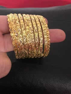 Intricate and classic. Pure silver 92.5 bangles! The details worth falling for❤️ A pure handcrafted and 24 KT gold plating over pure silver 92.5 bangles set, this festive season. Love these creations!! Absolutely stunning Bangles set : 8 piece Bangles set included: 6 bangles and two kadas Size : 2.6 Silver weight: 80.00 Garam and 200.00 milligrams Can be customize in any size. Made to order and shipping time 4-6 weeks. Wedding Filigree Bangle Jewelry, 22k Gold Cutdana Bracelet For Gift, Traditional Filigree Bangle For Festive Occasions, Festive Filigree Bangle, 22k Gold Cutdana Bangle As Gift, Traditional Ceremonial Bangle With Filigree, Silver Bangle For Ceremonial Occasions, Diwali, 22k Gold Hallmarked Bangle For Festive Occasions, Festive 22k Gold Hallmarked Bangle