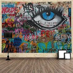 an empty room with graffiti on the wall and a large eye painted on the wall