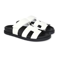 This pair of Chypre Techno sandals are in White calfskin and feature the iconic H, Black rubber soles, and adjustable straps.Origin: ItalyCondition: New and never wornAccompanied by: Hermes box, dustbagsSize: 36.5 EU Luxury Double Strap Calf Leather Sandals, Luxury Sandals With Double Strap And Branded Insole, Luxury Double Strap Sandals, Designer Calf Leather Sandals With Cushioned Footbed, Modern White Sandals With Rubber Sole, White Open Heel Sandals In Calf Leather, Luxury Sandals With Leather Sole And Double Strap, Luxury Sandals With Double Strap And Leather Sole, Luxury White Leather Slides