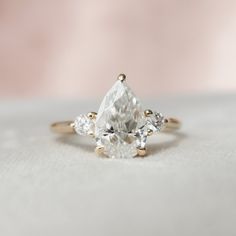 an engagement ring with three pear shaped diamonds