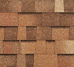 a close up view of a roof with brown shingles