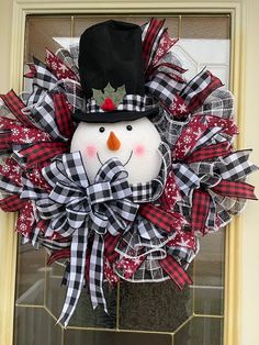 a snowman wreath is hanging on the front door