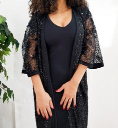 Jaw dropping piece. The Arabella kimono features a maxi silhouette, ornate sequin embellishment throughout, and finished with handmade black silk trimming for a luxurious look. Let's get this party started. Only one available DETAILS Lace embellished with sequins Handmade silk Sfifa Trimmings Fully Lined Black Maxi Length 1.40 meter /55 inch One size fits all Dry clean only Handmade in Morocco Got a question!! don't hesitate to contact me :) Elegant Festival Kimono, Spring Party Long Kaftan Dress, Spring Party Long Dress Kaftan, Fitted Kaftan For Summer Evening, Fitted Kaftan For Evening In Summer, Chic Long Kaftan For Evening, Summer V-neck Kaftan For Party, Fitted Kaftan For Evening And Summer, Chic Long Evening Kaftan