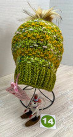 One-of-a-kind, ready-to-ship, handmade winter hat/beanie.  Bursting with color, this green, and mustard yellow multi-colored beanie features a 4" gold, faux fur, removable PomPom.  Made of fine Malabrigo Rasta wool yarn, this beanie must be hand washed and dried flat to preserve its softness and durability.  The hat measures 8" across and 9" tall allowing the wearer to pull it down over the ears or roll it up depending on the required warmth.  Knit from my own original design, The Poppy Hat pattern is available on Ravelry for the adventurous beginning knitter.  As with any handmade item, minor flaws and imperfections are inherent to its construction and adds a unique charm to the finished project. Handmade Multicolor Fall Hats, Yellow Hat For Fall, Yellow Hat For Fall, One Size Fits Most, Green Winter Hat For Cold Weather, Multicolor One Size Beanie For Fall, Green Outdoor Hat For Fall, Yellow Hand Knitted Beanie Crochet Hat, Green Warm Winter Hat, Green Slouchy Yarn Hat