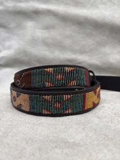 The Belts are made from ethically sourced leather in Kenya. The collars are then hand beaded by Maasai women artisans from my Village in Kajiado who have mastered the art. The hardware is made from 100% recycled brass. TO MEASURE CORRECTLY If you know your pants waist size, you can follow the add-two-inches rule i.e if your pants waist measurement is 32 Inches, then your belt size will be 34-36 Inch Belt. Our measurements are from the tip of the Buckle of the Belt to the second hole after the be Handmade Belt, Boho Belt, Boho Belts, Handmade Belts, Belt Men, Belt Leather, Beaded Belt, Jean Belts, Casual Belt