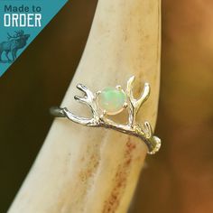 We are excited to introduce THE BETSY! We worked with an amazing artisan out of California to make this handmade beauty. This ring features a beautiful raw opal gemstone sitting gracefully against a glowing branch made of Sterling Silver. ABOUT THIS RING Gemstone: Cabochon Opal Metal: Sterling Silver Color/Finish: Silver, Polished QUESTIONS ABOUT SIZING Go to our Ring Sizing Guide for details and important guidance. CARE INSTRUCTIONS SPECIFIC TO THIS PRODUCT Sterling Silver High shine sterling s Antler Engagement Ring, Antler Rings, Stylish Engagement Rings, Antler Wedding Band, Deer Antler Ring, Twig Branch, Antler Ring, Alternative Engagement Ring, Engagement Ring For Her