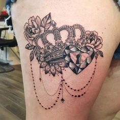 a woman's thigh with a crown tattoo on it