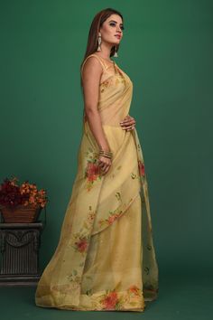 A very unique saree with Handloom Cotton Silk fabric till the pleats and Chanderi fabric with Bronze motifs which is translucent in the front. It also has a Pallu with bronze weave and fringes which makes the whole saree really exquisite. The entire saree has a Golden border. Enhance with a beautiful floral pattern, the vintage design enhances the royal look of the saree. Made with an intricate technique, this is a heritage of its own kind. With a rich border enveloping the saree, it is a stella Transitional Pre-draped Chanderi Saree With Sheer Dupatta, Transitional Tissue Silk Pre-draped Saree, Transitional Cotton Silk Saree With Sheer Dupatta, Pre-draped Chanderi Saree With Sheer Dupatta, Transitional Tussar Silk Saree With Sheer Dupatta, Chanderi Pre-draped Saree With Pallu, Cotton Silk Saree With Self Design For Reception, Reception Cotton Silk Saree With Self Design, Floor-length Organza Pre-draped Saree With Pallu