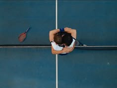 a tennis player with his head down on the court