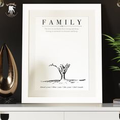 a black and white poster on a shelf next to a vase with a plant in it