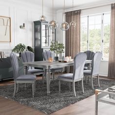 a dining room table with chairs and a rug