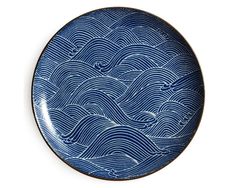 a blue and white plate with waves on it