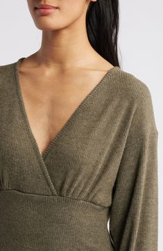 Soft ribbing textures this Empire-waist top designed with a low-dipping neckline and an eye-catching back cutout. 22 1/2" length Ties at back Surplice V-neck Long sleeves 78% rayon, 18% polyester, 4% spandex Machine wash, dry flat Imported Seamless V-neck Knit Top For Fall, Fitted V-neck Crop Top For Loungewear, Seamless V-neck Knit Top, Fitted V-neck Tops For Loungewear, Fitted V-neck Knit Top For Loungewear, Solid V-neck Knit Top For Loungewear, Seamless V-neck Tops For Fall, Seamless V-neck Fall Top, Fall Seamless V-neck Top