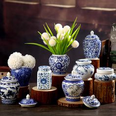 blue and white vases with flowers in them