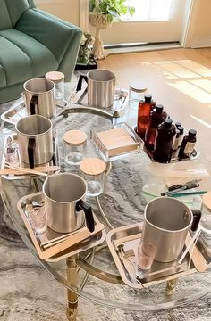 a glass table topped with cups and saucers