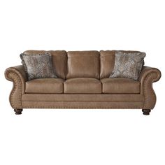 a brown couch with two pillows on it