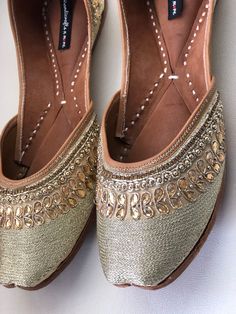 Timeless beauty is 'GRACEFUL GOLD' to be clubbed with any outfit to get the stunning glaze. This jutti with gold embroidery and beads is a contemporary classic pair of juttis which is a perfect accompaniment to just about anything. *Ethnic Shoes/Women Flats/Handmade Indian Designer Women Shoes or Slippers/Royal shoes/traditional style Women SPECIFICATIONS: *Upper/Panna - Gold fabric with embroidery, rhinestones and beads *Back/Adda - Gold fabric with embroidery, rhinestones and beads *Lining - L Royal Shoes, Embroidery And Beads, Punjabi Jutti, Bridal Women, Women Flats, Contemporary Classic, Gold Embroidery, Gold Fabric, Indian Designer