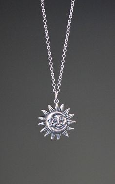 "This beautifully detailed Bali Silver Sun and Moon charm dangles from a silver chain. The chain is adjustable and can be worn close to the neck at 16\" or a little longer at 18\". It is finished with a silver lobster clasp. Please send a message if a longer chain is desired. Wear this necklace by itself or as a layering piece. Coordinating earrings are available... www.etsy.com/listing/1175529018/silver-sun-earrings Silver Sun and Moon pendant: 19mm Total length of charm: 1\" Silver chain: 1.5m Sun And Moon Jewelry Silver, Sun Necklace Silver, Sterling Silver Sun And Moon Pendant Charm Necklace, Sterling Silver Pendant Necklace With Sun And Moon Design, Bohemian Sterling Silver Charm Necklace With Adjustable Chain, Silver Moon Jewelry With Adjustable Chain, Silver Moon Necklace For Festival, Silver Moon Shaped Jewelry For Festivals, Silver Moon-shaped Jewelry For Festivals