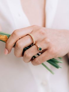 A round Emerald is delicately bezel set in a gold hammered band, along with a bezel set diamond and gold Dew Drop detail.This dainty everyday ring can be worn as a stackable set or on its own. Size: 7 Emerald Gemstone measures 5mm Diamond carat weight 0.03 14k yellow Gold Looking for a different ring size? Contact us at hello@meusshop.com Designed by Anzie Elegant Emerald Ring With Bezel Setting, Emerald Ring With Bezel Setting, Elegant Everyday Stackable Rings With Bezel Setting, Fine Jewelry Stackable Rings With Bezel Setting, Stackable Emerald Ring With Round Band, Heirloom Solitaire Emerald Ring, Everyday Diamond Ring With Bezel Setting, Timeless Bezel Set Rings For May Birthstone, Timeless Bezel Set Rings With May Birthstone