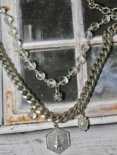 This is a fun eclectic double strand necklace. The Eiffel Tower Charm and the Crown are sterling silver. The perfect gift for that someone special. I T E M ∙ S P E C I F I C A T I O N S: - CHAIN LENGTH: Necklace is made with silver chain and crystal rosary bead chain. Silver chain is not sterling. Double Strand- Short strand is 20" in length, Longest Strand is 24" - you can link the clasp in another loop and make it shorter if you prefer. - PENDANT SIZE: Sterling Silver Crown is 1/2" long, Paris Silver Double Strand Necklace, Silver Charm Necklaces With Vintage Charm For Anniversary, Vintage Silver Charm Necklaces For Anniversary, Silver Vintage Charm Necklace For Anniversary, Vintage Silver Charm Necklace For Anniversary, Silver Nickel-free Necklaces For Layering, Silver Double Chain Charm Necklaces, Silver Multi-strand Charm Necklaces As Gift, Silver Multi-strand Charm Necklace As Gift