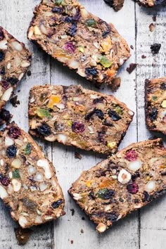 several pieces of fruit and nut bread on a table