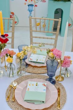 a table set with place settings and flowers