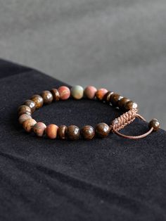 This bracelet is made with natural polished Bronzite Jasper and matte Picasso Jasper in size 8mm. Beautiful elegant yet minimalist design is perfect gift for self or your loved ones. Bracelet is 7'' long and has adjustable macrame knot that enables the cords to slide through and expand in size for comfortable fit.  Bronzite is used for protection, as it not only repels, but also sends back the negative energies to the sender. Spiritually, Bronzite assists us in achieving a state of certainty without willfulness, allowing us to easily adapt to the best path to take. It clears confusion, helping our ability to make decisions and choices about our life path. Bronzite is a "stone of courtesy", especially helpful to people who greet and assist the public. It will even instil a polite nature in Men Beaded Bracelet, Gift For Self, Old Friendships, Anniversary Gift For Husband, Picasso Jasper, Macrame Knot, Anniversary Gifts For Husband, Mala Bracelet, Bracelet Gemstone