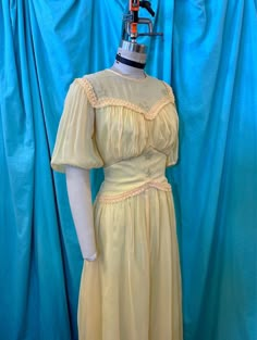 "1930s/1940s W:28 yellow sheer rayon short puff sleeve illusion neckline star sequin braid trim runched shelf bust drop waist party dress. THIS FEATURES * Yellow sheer rayon mesh like base * Full yellow fille acetate lining * Short puff sleeves * Elastic sleeve hem * Illusion crew neck * Sequin star details * Braid trim detailing * Sweetheart runched bust * Shelf bust design * Fitted waist * Drop waist design * Button up back closure * Self covered buttons/loops * Gathered skirt waist * A-line s Fitted Yellow Vintage Dress For Party, Yellow Fitted Vintage Dress For Parties, Fitted Yellow Vintage Dress With Short Sleeves, Yellow Fitted Vintage Dress With Short Sleeves, Yellow Vintage Dress For Spring Daywear, Vintage Yellow A-line Dress, Yellow Fitted Short Sleeve Vintage Dress, Drop Sleeve Dress, Vintage Yellow Puff Sleeve Dress