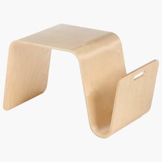 a small wooden stool with one foot on the ground and another leg off to the side