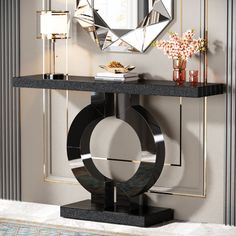 a black table with a mirror and vase on it in front of a white wall