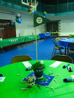 a green table topped with a potted plant next to a basketball hoop