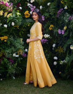 Capture the essence of elegance in this saffron-colored chanderi brocade anarkali, adorned with exquisite lurex patchwork and intricate thread embroidery. This stunning ensemble comes complete with a graceful organza dupatta and pants, offering a harmonious blend of tradition and modernity. Crafted from luxurious chanderi brocade, it radiates sophistication, making it the perfect choice for any special occasion where you want to shine with style and grace. Yellow Floor-length Churidar With Chikankari Embroidery, Yellow Floor-length Chikankari Churidar, Gold Anarkali Kurta With Chikankari Embroidery, Gold Chikankari Embroidery Anarkali Set For Navratri, Gold Chikankari Anarkali Set For Navratri, Slub Silk Lawn Suit With Gota Work For Wedding, Wedding Lawn Suit With Gota Work In Slub Silk, Gold Anarkali Set With Chikankari Embroidery For Eid, Gold Chanderi Lawn Suit With Chikankari Embroidery