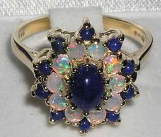 *This ring is made from 750 18K Yellow Gold with Natural Lapis Lazuli & Fiery Opal gemstones.PLEASE ALSO MAKE SURE YOU STATE YOUR TELEPHONE NUMBER WITH YOUR PAYMENT AS THIS MAY BE REQUIRED BY THE SHIPPING CARRIER.This is a WOW! factor ring, showcasing a large 7x5mm (0.28"x0.20" inches) centre vibrant Lapis Lazuli complimented by ten 2.75mm (0.11" inches) fiery Opals and ten 2.25mm (0.09" inches) Lapis Lazuli. A real beauty that is guaranteed to impress.This ring is handcrafted from Solid English Blue Hallmarked Opal Ring For Wedding, Antique Blue Multi-stone Jewelry, Victorian Multi-stone Opal Ring As Gift, Victorian Multi-stone Opal Ring For Gift, Victorian Multi-stone Opal Ring, Blue Multi-stone Antique Rings, Antique Multi-stone Blue Rings, Antique Blue Multi-stone Rings, Cluster Ring Set