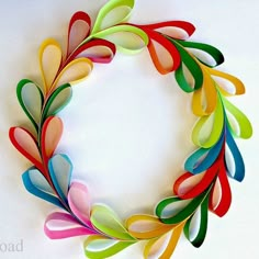 an image of a colorful wreath made out of strips of colored paper with the words fold strips into a colorful wreath