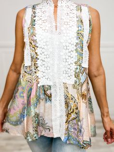 Floral meets playful in our Mock Neck Sleeveless Woven Top. Trim Point Lace Accents add a touch of whimsy. Perfect for adding a pop of fun to any outfit. Fabric- 100% Polyester Chic Spring Tank Top With Lace Patchwork, Chic White Lace Patchwork Tank Top, Chic Sleeveless Top With Crochet Trim, Chic White Tank Top With Lace Patchwork, Feminine Lace Patchwork Tank Top For Spring, Feminine Lace Patchwork Tank Top For Summer, Feminine Summer Tank Top With Lace Patchwork, Feminine Sleeveless Tops With Crochet Trim, Multicolor Sleeveless Dress With Lace Patchwork