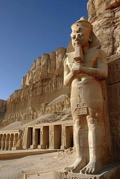 an ancient egyptian statue in front of the great temple at abut el - amar