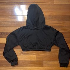 Black Cropped Hoodie. Never Worn Black Stretch Fleece Outerwear, Black Fleece Hoodie For Fall, Black Hoodie With Ribbed Cuffs For Loungewear, Black Urban Hoodie For Loungewear, Black Fleece Hoodie For Loungewear, Black Hoodie Sweatshirt For Loungewear, Black Fleece Sweatshirt With Adjustable Hood, Black Hoodie For Loungewear, Black Athleisure Hoodie With Double-lined Hood