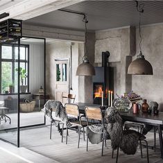 a dining room with chairs and a ladder hanging from the ceiling, next to a table