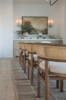 a row of wooden chairs sitting next to each other on top of a hard wood floor