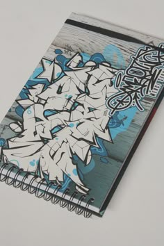 a notebook covered in graffiti sitting on top of a table