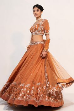 Ochre brown lehenga, accentuated with floral embroidery in cutdana and sequin embellishments. Paired with a half sleeve, sweetheart neckline blouse, highlighted with pearl, cutdana and sequin embellishments in floral pattern. Comes with a floral embroidered border dupatta.
Component: 3
Pattern: Embroidery,Embellished
Type Of Work: Floral,Pearl,Sequin,Cutdana
Neckline: Sweetheart Neck
Sleeve Type: Half Sleeves
Fabric: Silk, Organza
Color: Brown
Other Details: 
Floral embroidered waistband
Fabric Brown Lehenga, Embroidered Lehenga, Embroidered Border, Designer Outfits, Embroidery Floral, Pattern Embroidery, Brown Silk, Indian Designer Outfits, Silk Organza