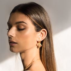 Brunette model wearing mismatched sacred heart earrings on one ear to show the size difference. Earrings To Make, Earring Hoop, Huggie Earring, Sacred Symbols, Large Heart, Mismatched Earrings, Red Gemstones, Mini Heart, Gold Dipped