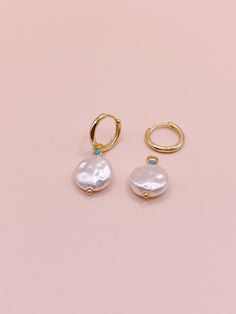 The Clara Pearl Huggies earrings offer a subtle touch of sophistication and timeless style. Crafted with sterling silver and 14k gold plating, these earrings feature an imitation pearl for a look of classic elegance. Light and dainty, these earrings offer two styles in one, with a charm option for added versatility. Pearl Huggies, Huggies Earrings, Classic Elegance, Gold Plating, Timeless Style, Timeless Fashion, Gold Plate, Plating, Sterling Silver